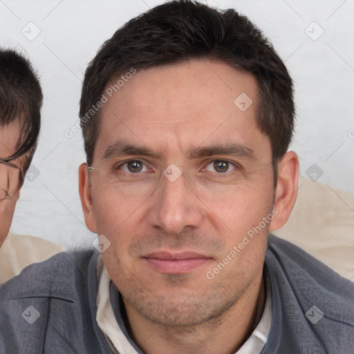 Joyful white adult male with short  brown hair and brown eyes