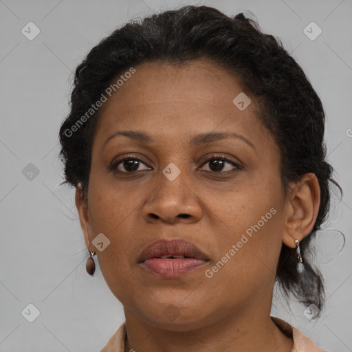 Joyful black adult female with medium  brown hair and brown eyes