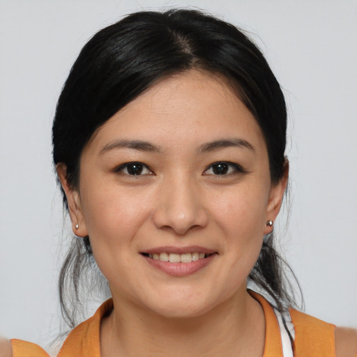 Joyful white young-adult female with medium  black hair and brown eyes