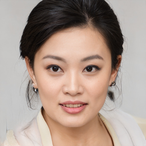 Joyful asian young-adult female with medium  brown hair and brown eyes