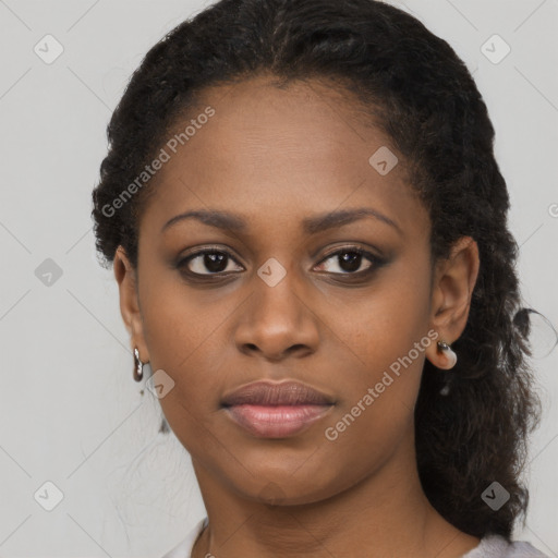 Joyful black young-adult female with long  black hair and brown eyes