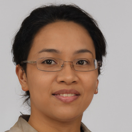 Joyful latino adult female with short  brown hair and brown eyes