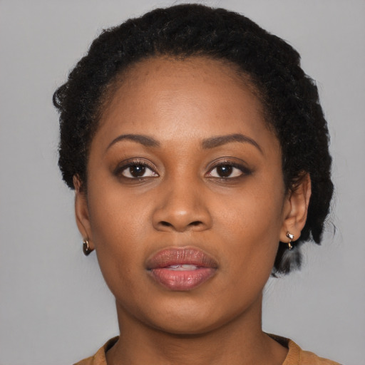 Joyful black young-adult female with short  brown hair and brown eyes