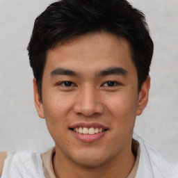 Joyful asian young-adult male with short  black hair and brown eyes