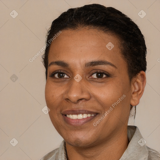 Joyful black young-adult female with short  black hair and brown eyes