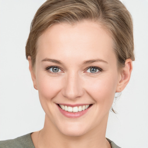 Joyful white young-adult female with short  brown hair and grey eyes