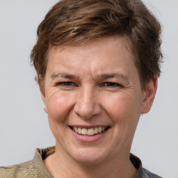 Joyful white adult male with short  brown hair and grey eyes