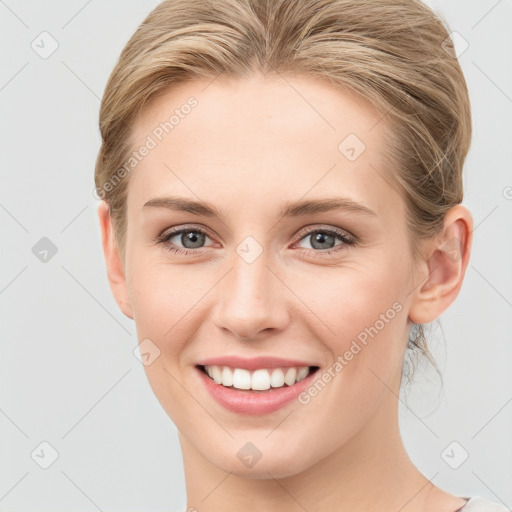 Joyful white young-adult female with medium  brown hair and blue eyes