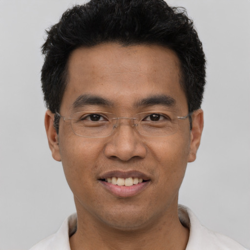 Joyful asian adult male with short  black hair and brown eyes