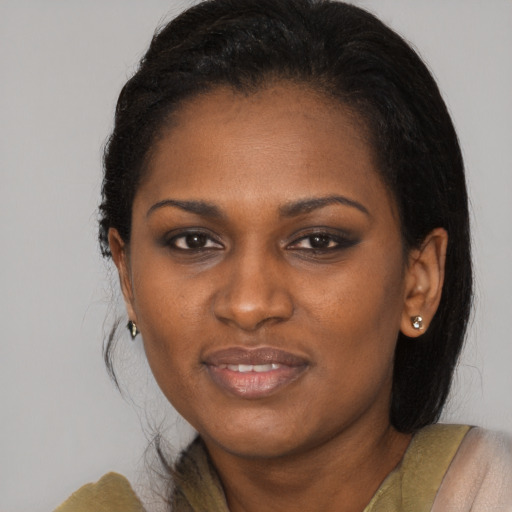 Joyful black young-adult female with long  brown hair and brown eyes