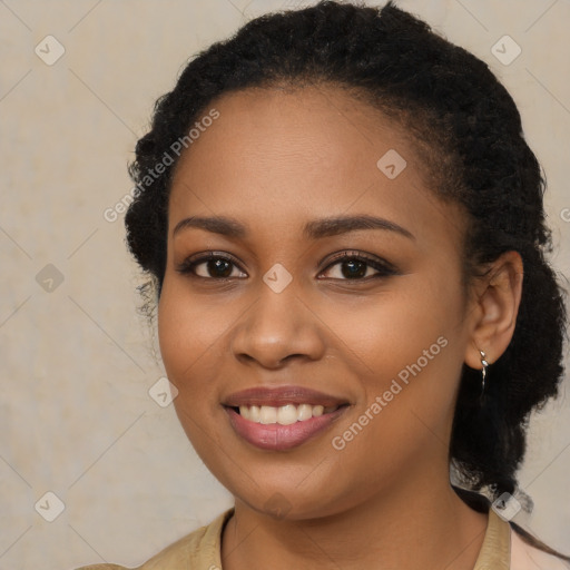 Joyful black young-adult female with long  brown hair and brown eyes