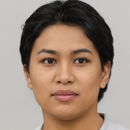 Joyful asian young-adult female with short  black hair and brown eyes