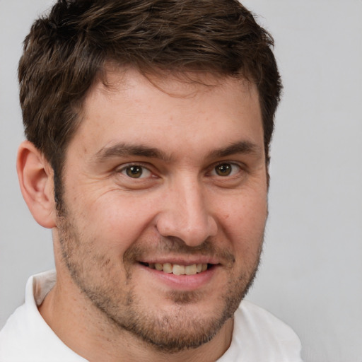 Joyful white adult male with short  brown hair and brown eyes