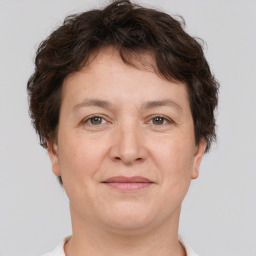 Joyful white adult female with short  brown hair and brown eyes