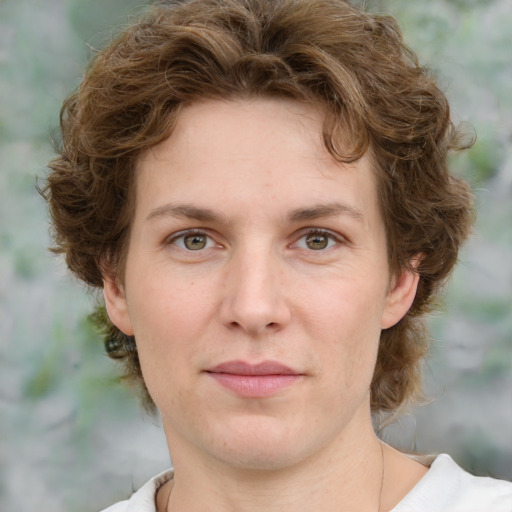 Joyful white young-adult female with medium  brown hair and green eyes