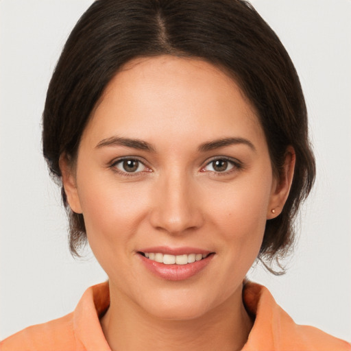 Joyful white young-adult female with medium  brown hair and brown eyes