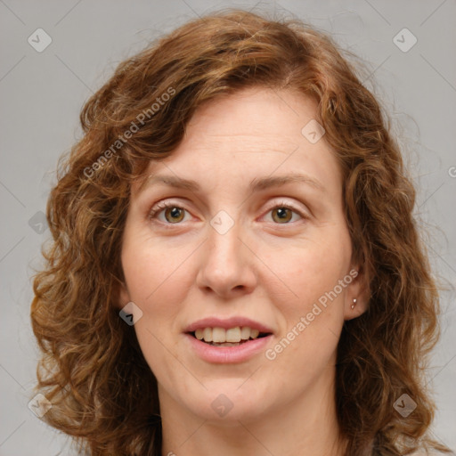 Joyful white adult female with long  brown hair and green eyes