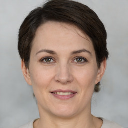 Joyful white adult female with short  brown hair and brown eyes