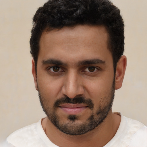 Joyful white young-adult male with short  black hair and brown eyes