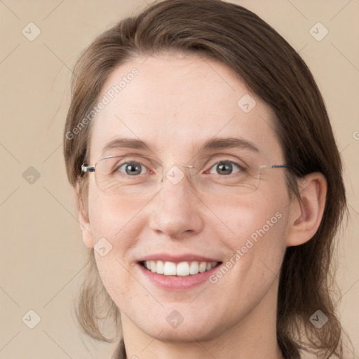 Joyful white adult female with long  brown hair and grey eyes