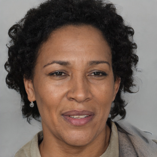 Joyful black adult female with short  brown hair and brown eyes