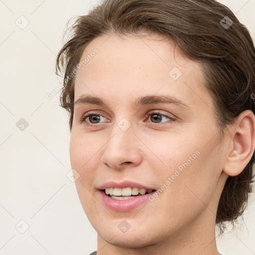 Joyful white young-adult female with medium  brown hair and grey eyes