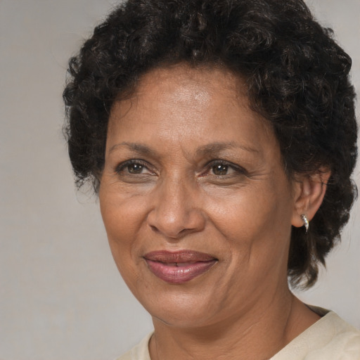 Joyful black adult female with short  brown hair and brown eyes