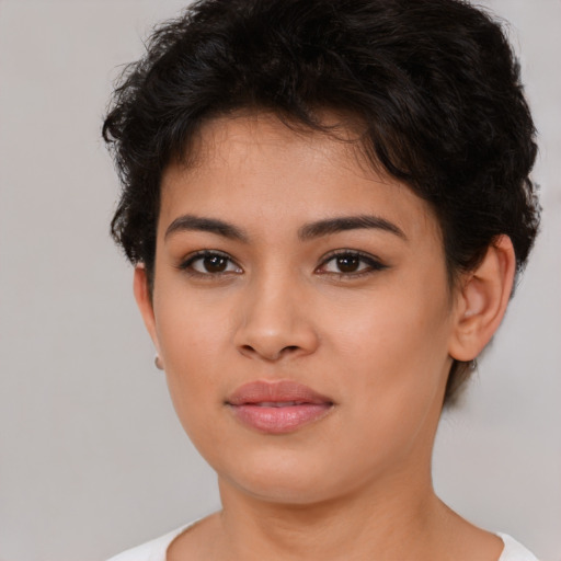 Joyful latino young-adult female with short  brown hair and brown eyes