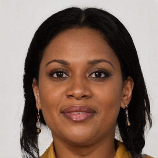 Joyful black young-adult female with long  brown hair and brown eyes