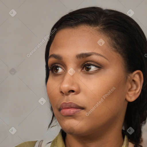 Neutral black young-adult female with medium  brown hair and brown eyes