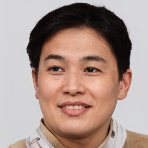 Joyful white adult male with short  brown hair and brown eyes