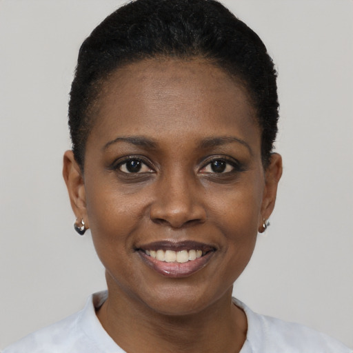 Joyful black young-adult female with short  black hair and brown eyes