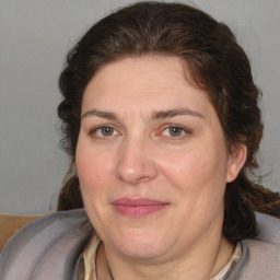 Joyful white adult female with medium  brown hair and brown eyes