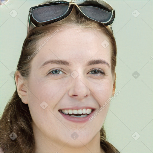 Joyful white young-adult female with long  brown hair and blue eyes