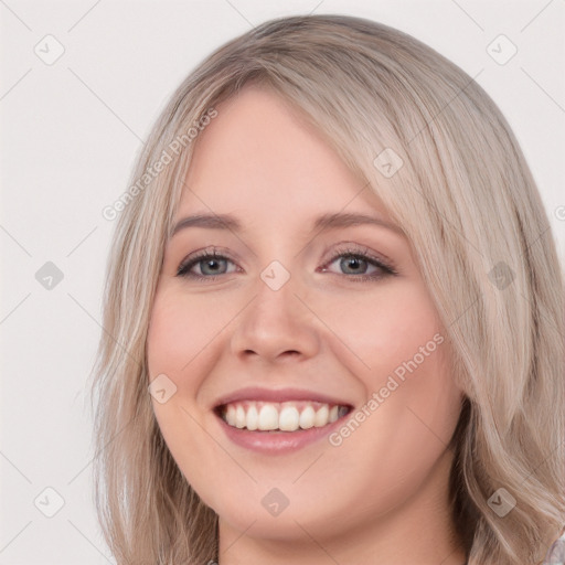 Joyful white young-adult female with long  brown hair and blue eyes