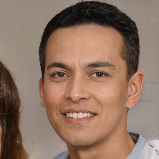 Joyful white adult male with short  brown hair and brown eyes