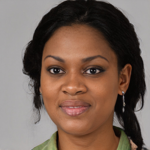 Joyful black young-adult female with medium  black hair and brown eyes