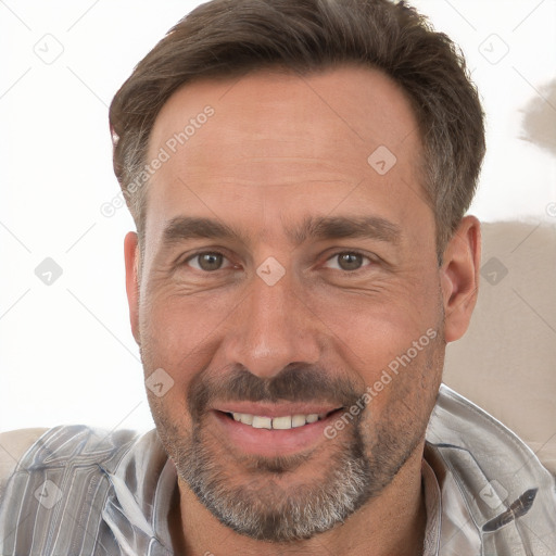 Joyful white adult male with short  brown hair and brown eyes