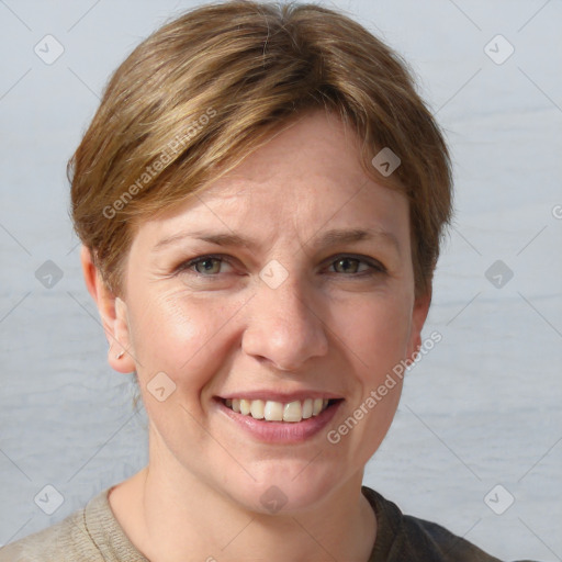 Joyful white adult female with short  brown hair and grey eyes