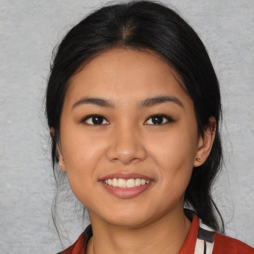Joyful asian young-adult female with medium  black hair and brown eyes