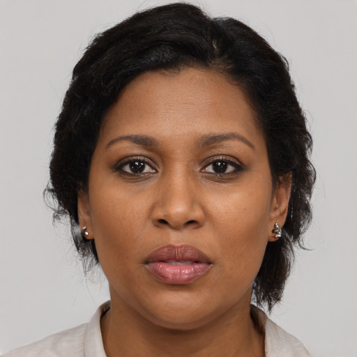 Joyful black young-adult female with medium  brown hair and brown eyes