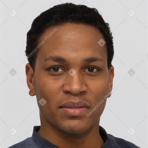 Joyful black young-adult male with short  black hair and brown eyes