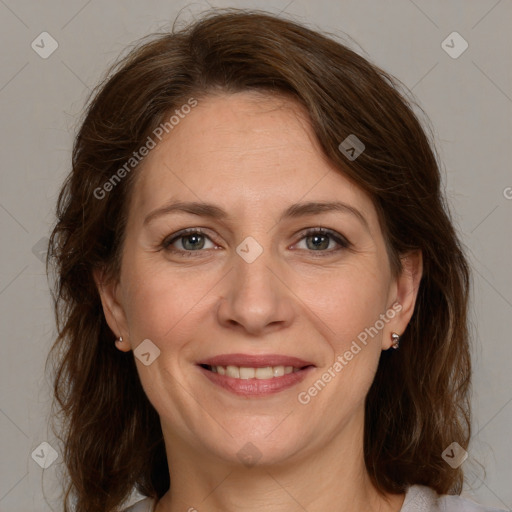 Joyful white adult female with medium  brown hair and grey eyes