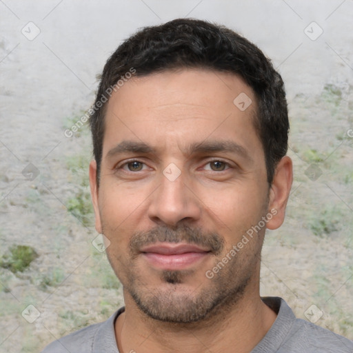 Joyful white young-adult male with short  black hair and brown eyes