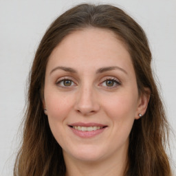 Joyful white adult female with long  brown hair and green eyes