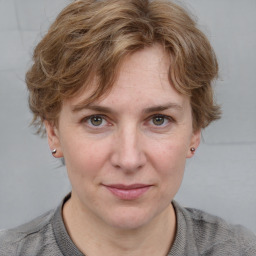 Joyful white adult female with medium  brown hair and blue eyes