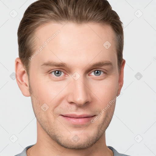 Joyful white young-adult male with short  brown hair and grey eyes