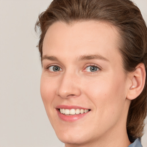 Joyful white young-adult female with medium  brown hair and blue eyes