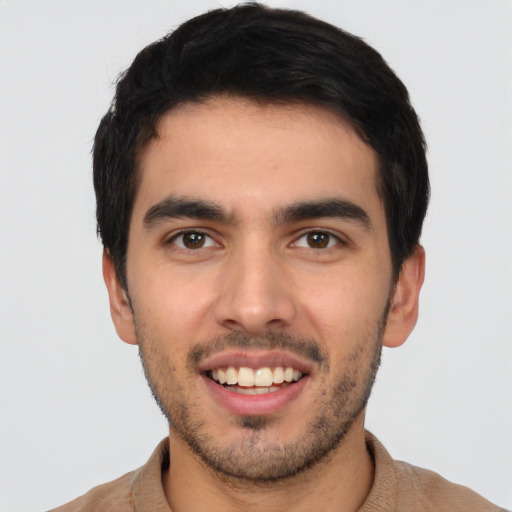 Joyful white young-adult male with short  black hair and brown eyes