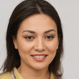 Joyful latino young-adult female with medium  brown hair and brown eyes